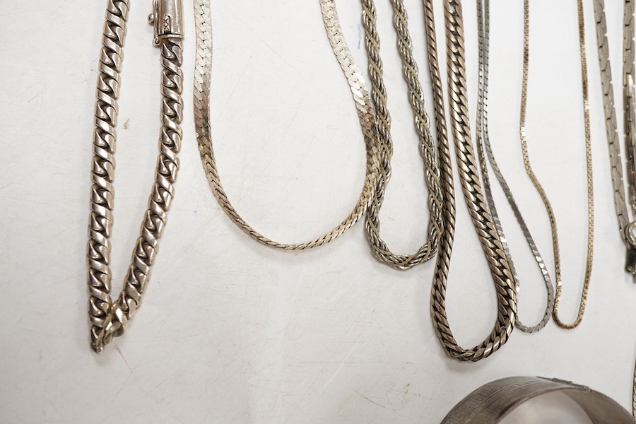 Two white metal bangles, one inscribed 'sterling silver' the other '925', together with a silver Uno A Erre chain, four other 925 chains, one curb link and four other white metal chains, longest approx. 69cm.
